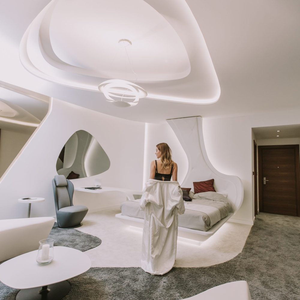 Pretty young woman standing in the modern white apartment